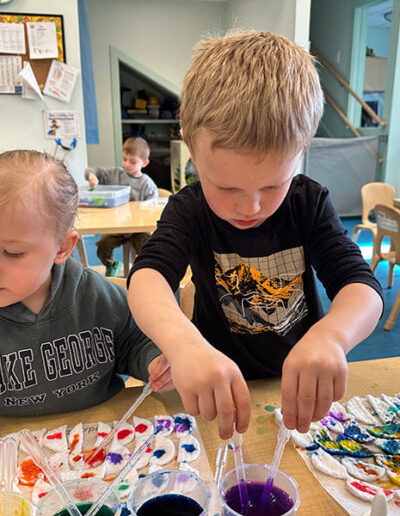 A preschool age boy and girl painting