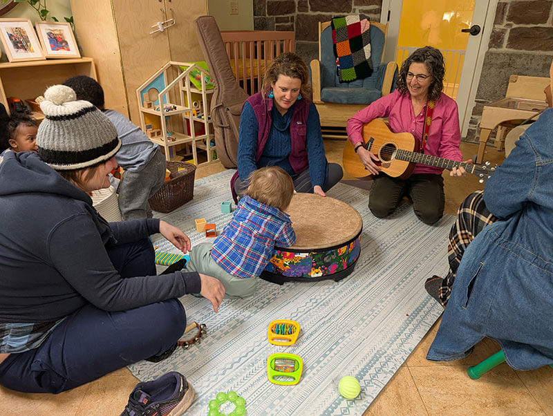 People playing music with young children