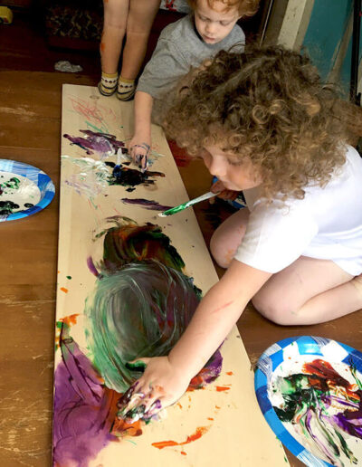 Two young children finger painting