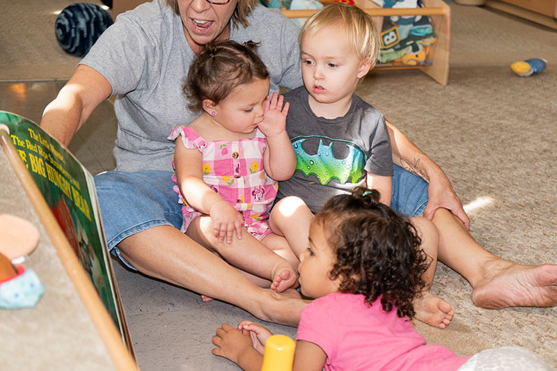 Young children being read to by a Heas Start teacher